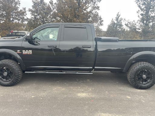 Black RAM truck with PPF, clean and glossy exterior.