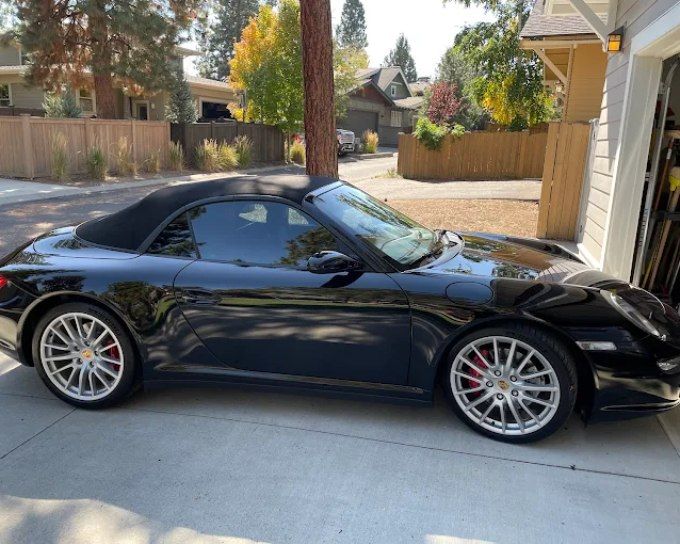 Black convertible sports car showing high-gloss shine after ceramic coating protection