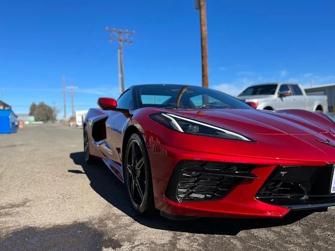 Red Chevrolet Corvette sports car showing mirror-like shine after ceramic coating in Redmond, OR