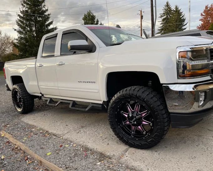 White lifted Chevrolet Silverado with ceramic coating applied by Perfection Plus Auto Salon