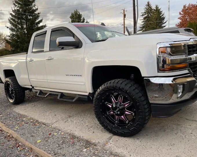 White lifted Chevrolet Silverado with ceramic coating, detailed by Perfection Plus Auto Salon