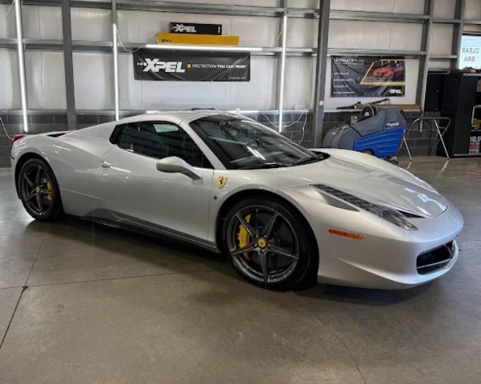 Silver Ferrari 458 with light tint darkness window film, detailed by Perfection Plus Auto Salon