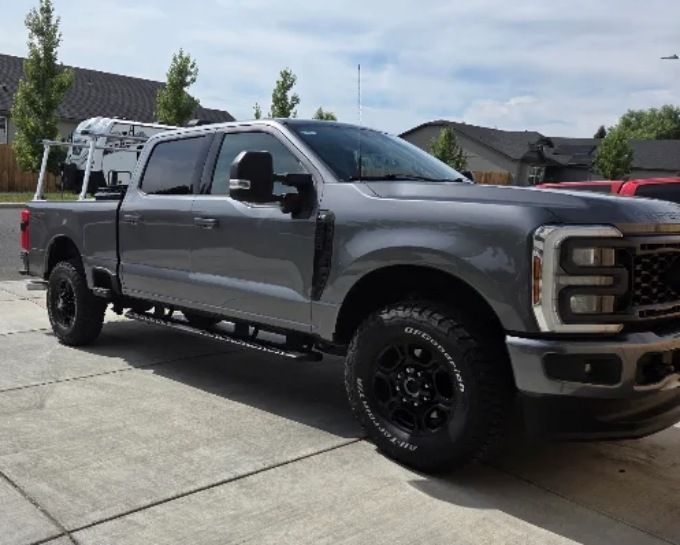 Gray lifted Ford F-250 with ceramic coating, parked in driveway