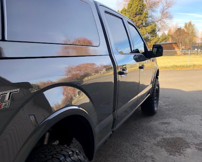 Black Ford truck side panel with PPF paint protection film, glossy finish in Redmond, Oregon