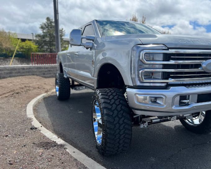 Lifted Ford truck with ceramic coating and off-road tires at Perfection Plus Auto Salon in Redmond, 