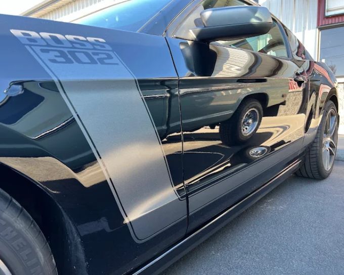 Black Ford truck with racing stripes protected by PPF, detailed by Perfection Plus Auto Salon