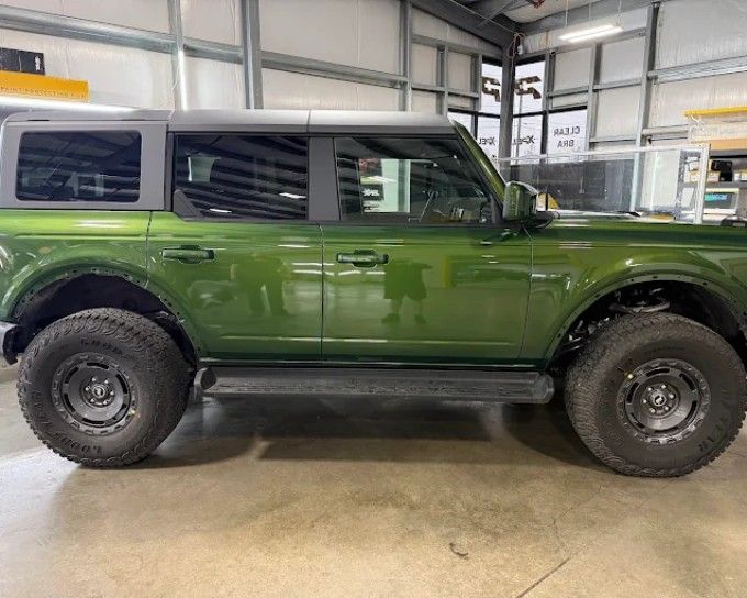 Green Ford Bronco with fresh window tint installed at Perfection Plus Auto Salon in Redmond, OR