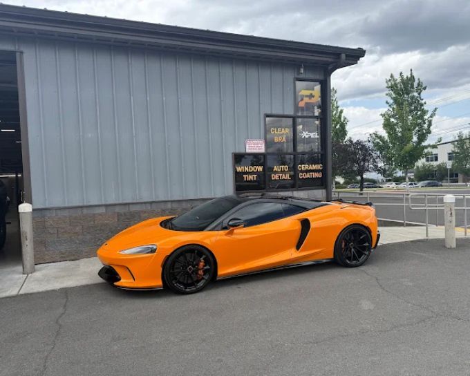 Orange McLaren sports car with ceramic coating outside Perfection Plus Auto Salon shop