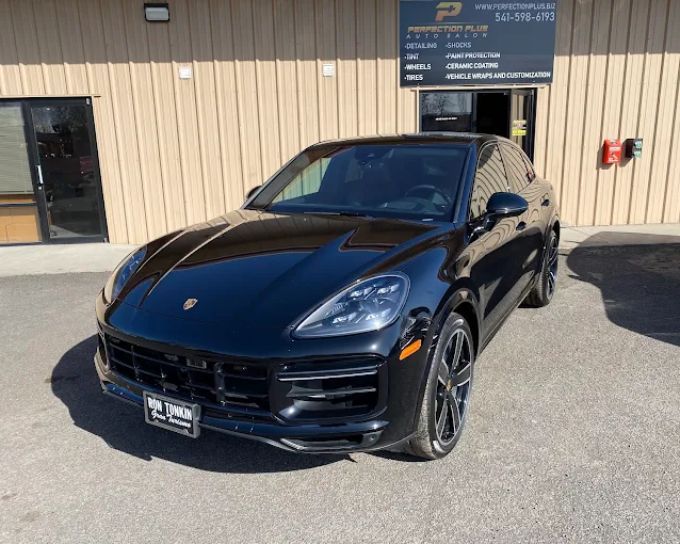 Black Porsche Cayenne with PPF paint protection outside Perfection Plus Auto Salon shop