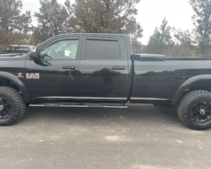 Black Ram truck with tinted windows and lifted suspension, Redmond OR