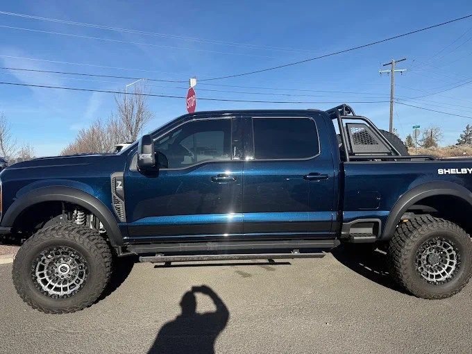 Lifted blue Shelby Ford Super Duty truck protected against road debris with PPF in Redmond, OR