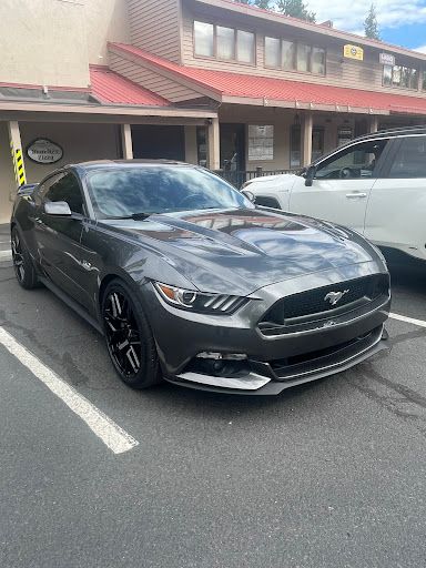 Gray Mustang with ceramic coating, clean and glossy, emphasizing reflective surface. 
