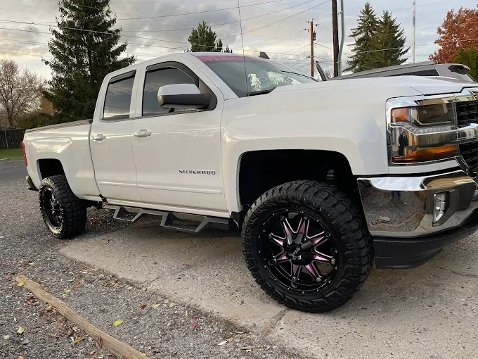 White pickup truck with ceramic coating, reflecting light, showcasing durability.