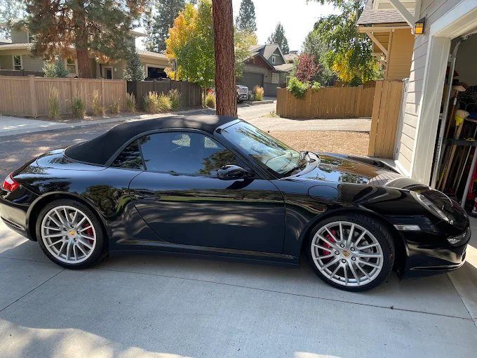 Black convertible sports car with UV-blocking window tinting in Redmond, OR