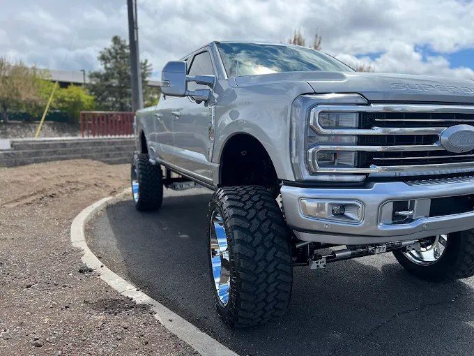 Lifted silver Ford Super Duty truck protected by ceramic coating in Redmond, OR