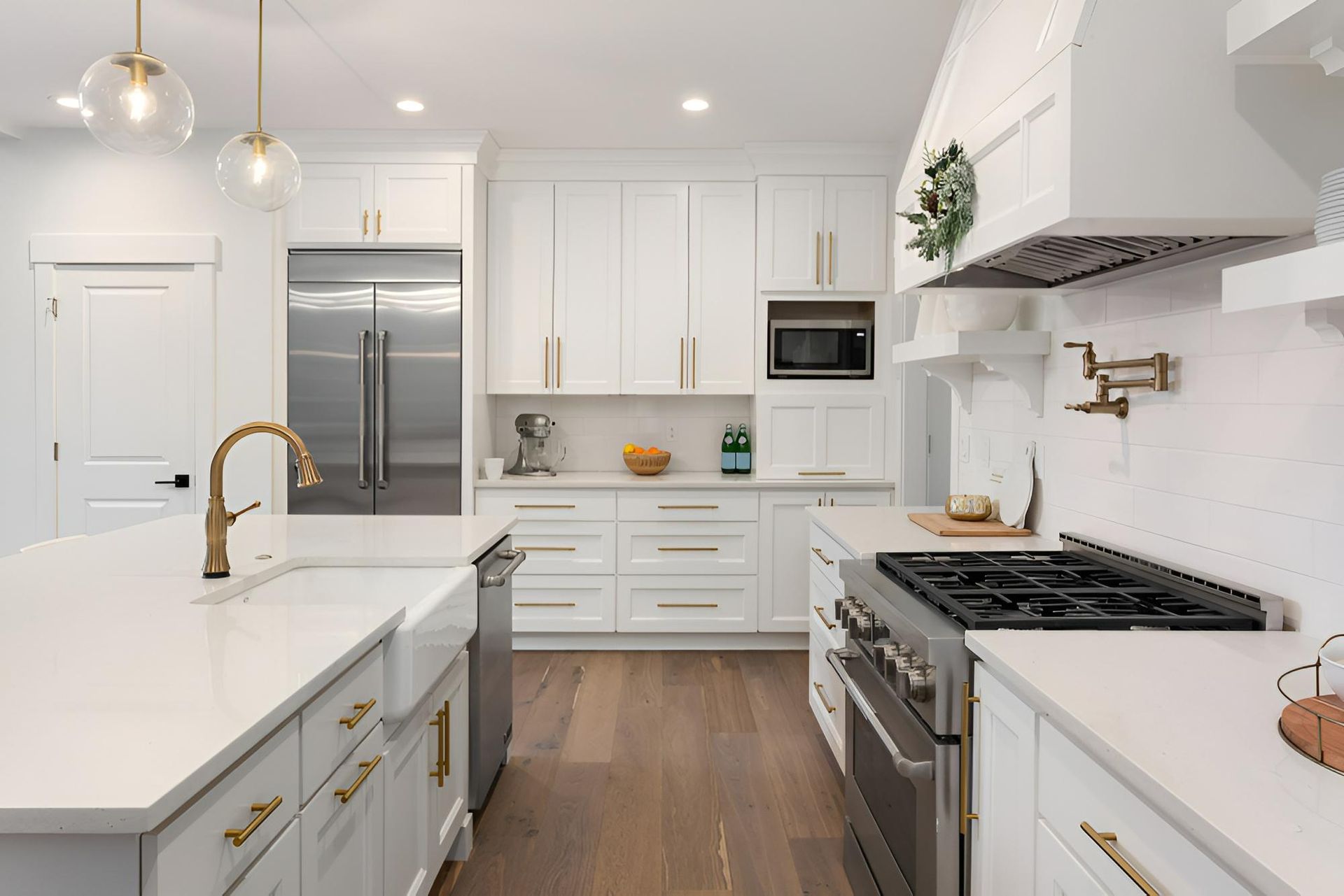 A Kitchen With White Cabinets, Stainless Steel Appliances, and a Large Island — Precision Kitchens & Cabinets in Ballina, NSW