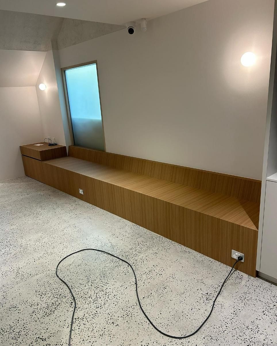 There is a Long Wooden Bench in the Middle of the Room — Precision Kitchens & Cabinets in Ballina, NSW