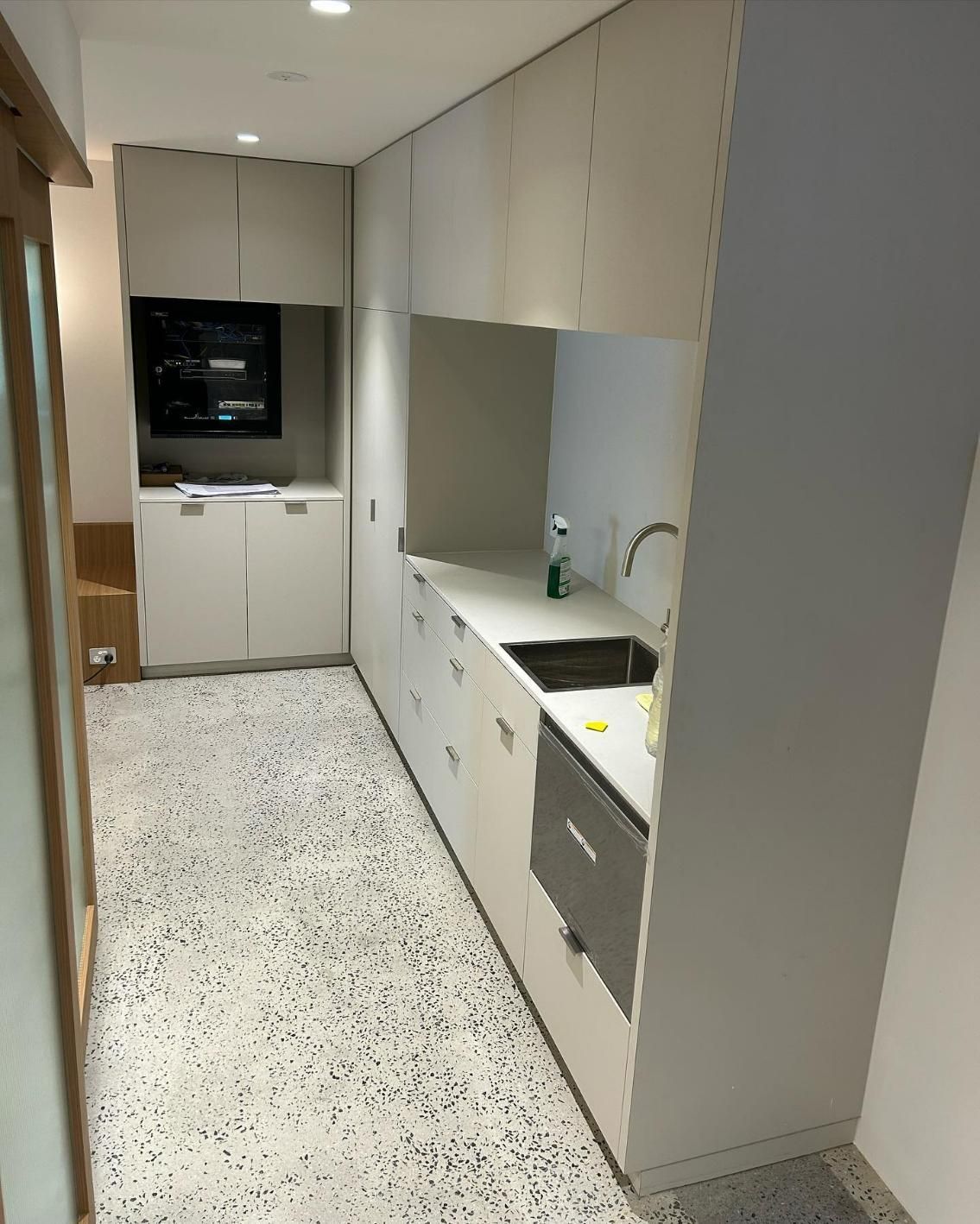 A Kitchen With White Cabinets and a Black Sink — Precision Kitchens & Cabinets in Ballina, NSW