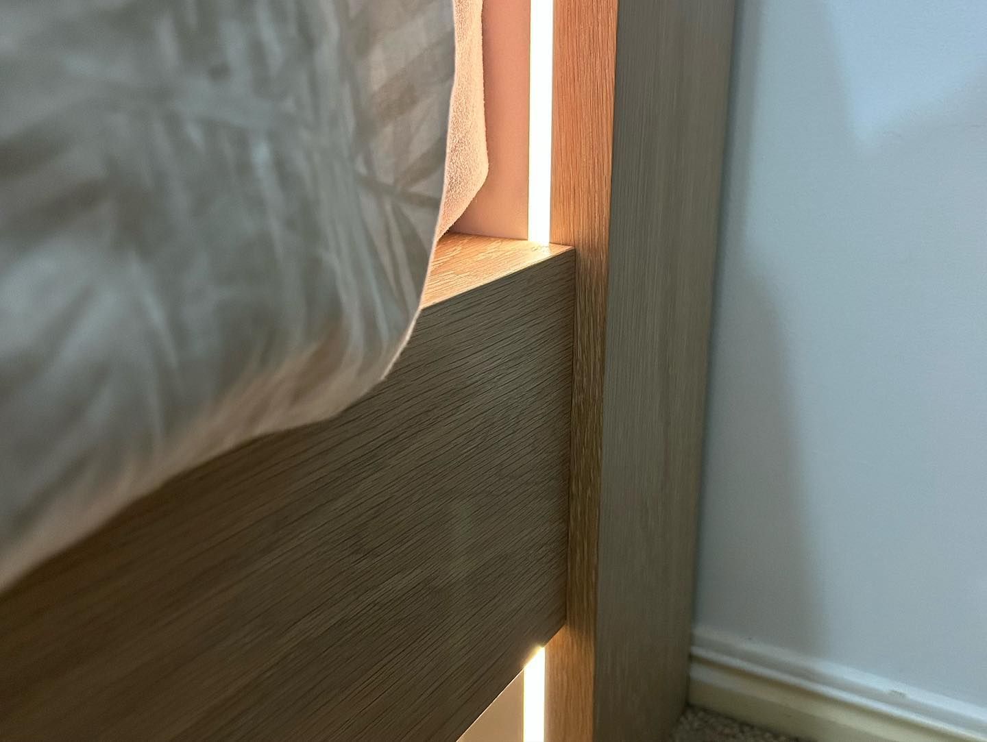 A Bed With a Light on the Side of It in a Bedroom — Precision Kitchens & Cabinets in Ballina, NSW