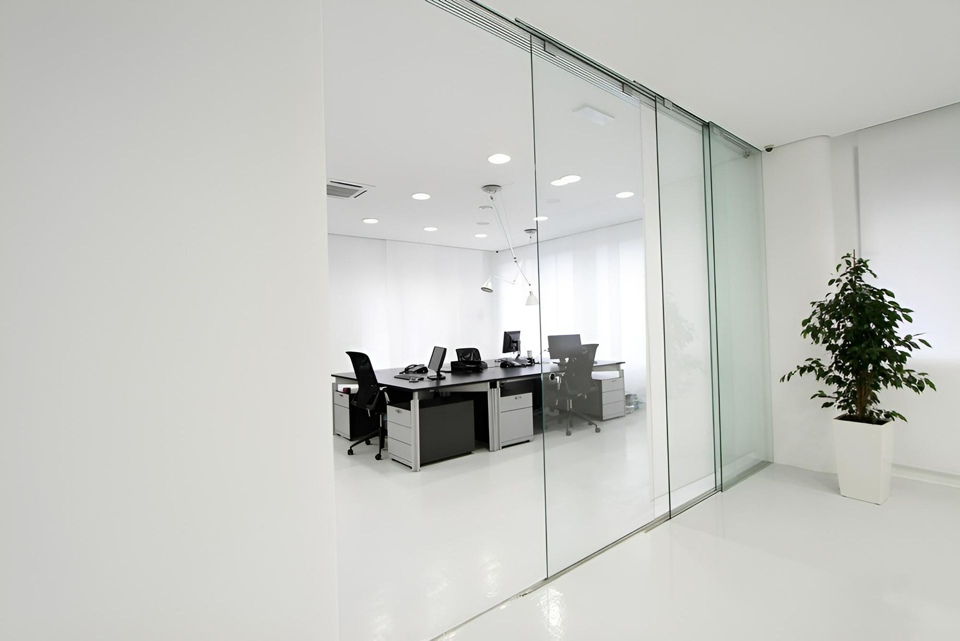 An Office With Sliding Glass Doors and Cubicles — Precision Kitchens & Cabinets in Kingscliff, NSW
