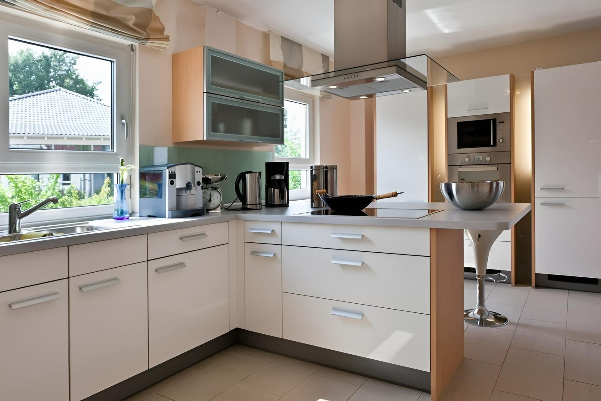 A Kitchen With White Cabinets and Stainless Steel Appliances — Precision Kitchens & Cabinets in Kingscliff, NSW