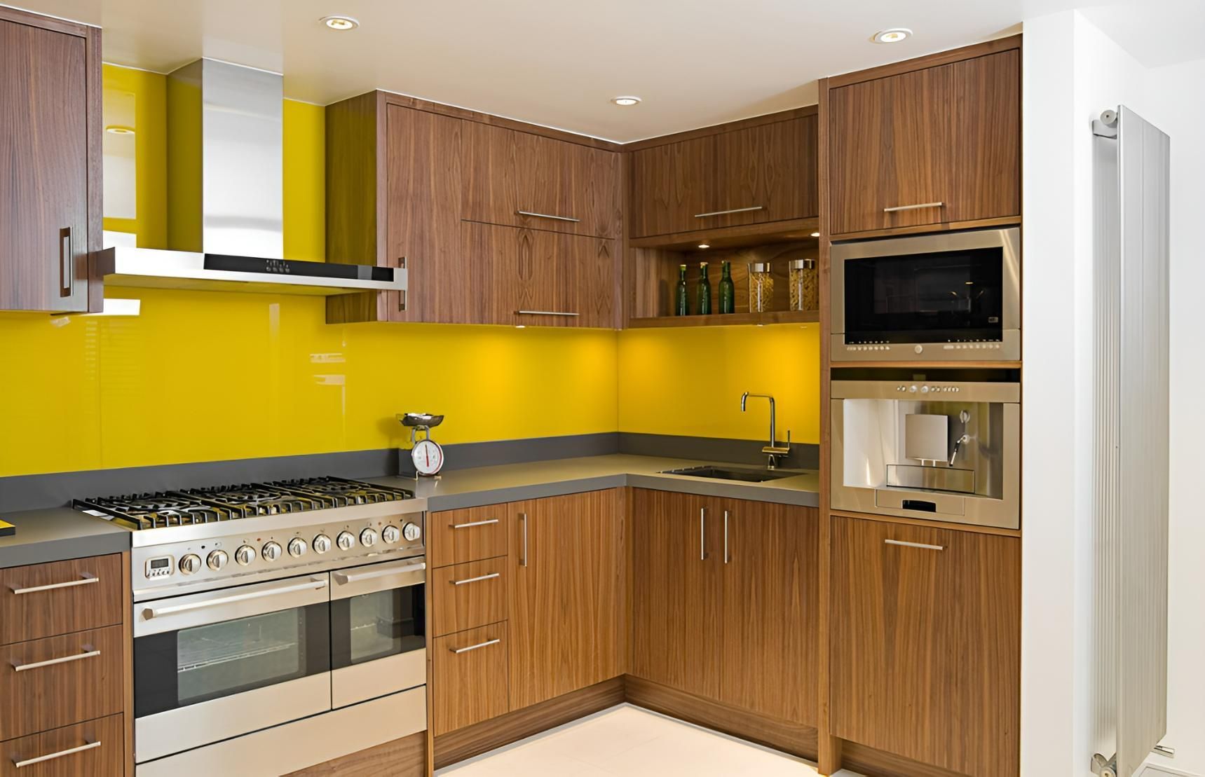A Kitchen With Wooden Cabinets and Stainless Steel Appliances — Precision Kitchens & Cabinets in Ballina, NSW