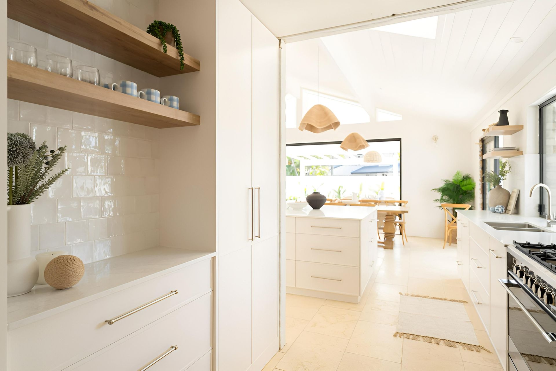 A Kitchen With White Cabinets, Wooden Shelves and a Stove — Precision Kitchens & Cabinets in Byron Bay, NSW