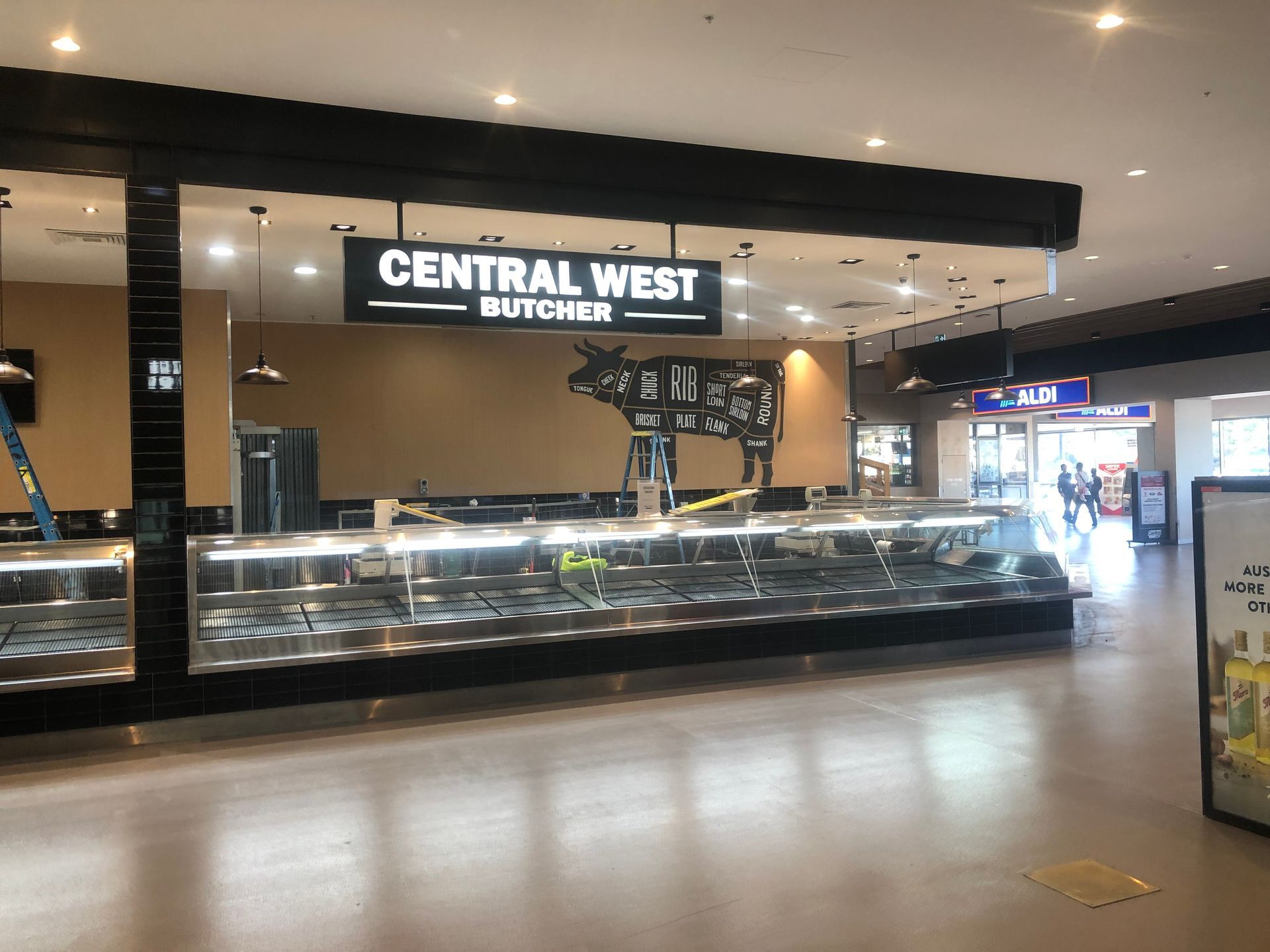 Central West Buffet sign above a long glass food counter in a brightly lit mall corridor