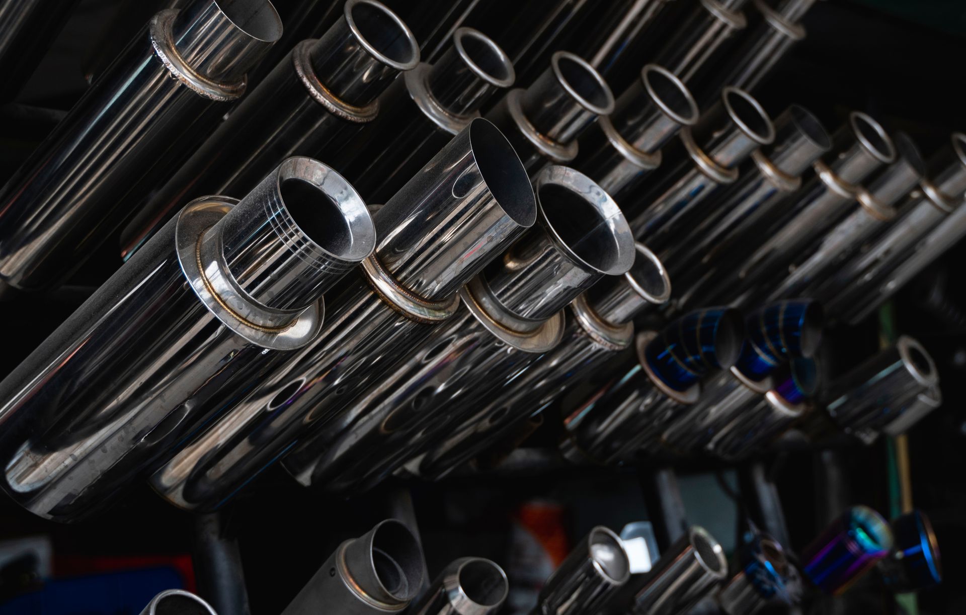 New and used motorcycle exhaust chrome pipes in a motorcykles shop or in service center. New and used motorcycle exhaust chrome pipes in a motorcykles shop or in service center.