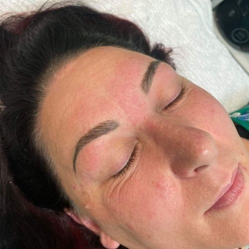 A close up of a woman 's face with her eyes closed.