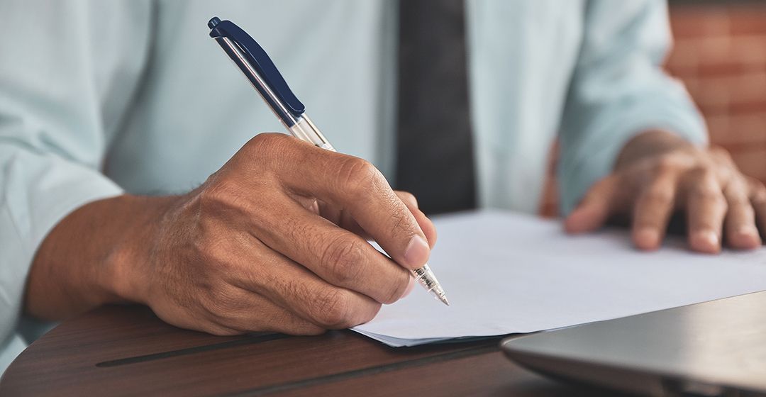 person planning with pen and paper