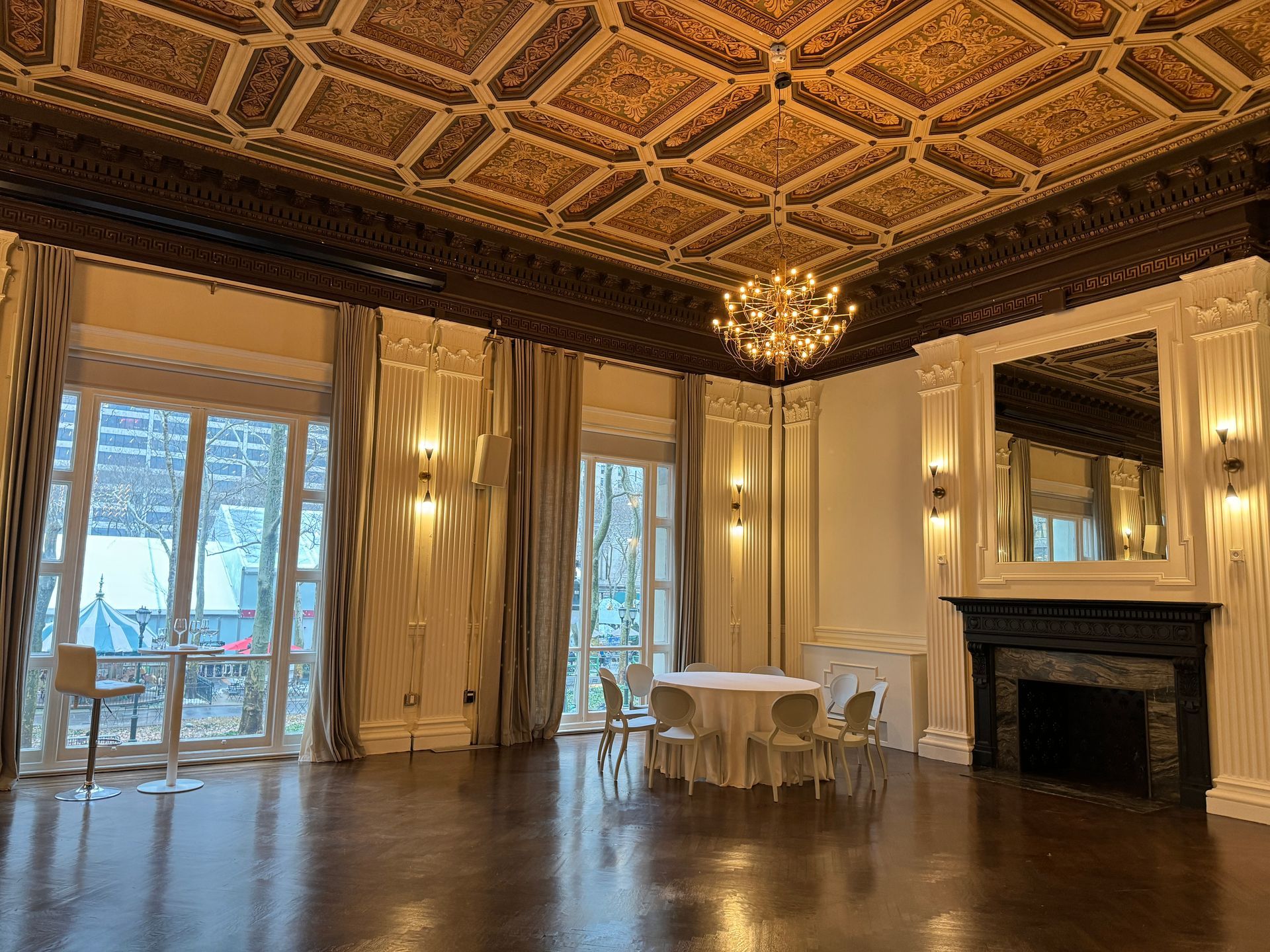 There is a table and chairs in the middle of the room.