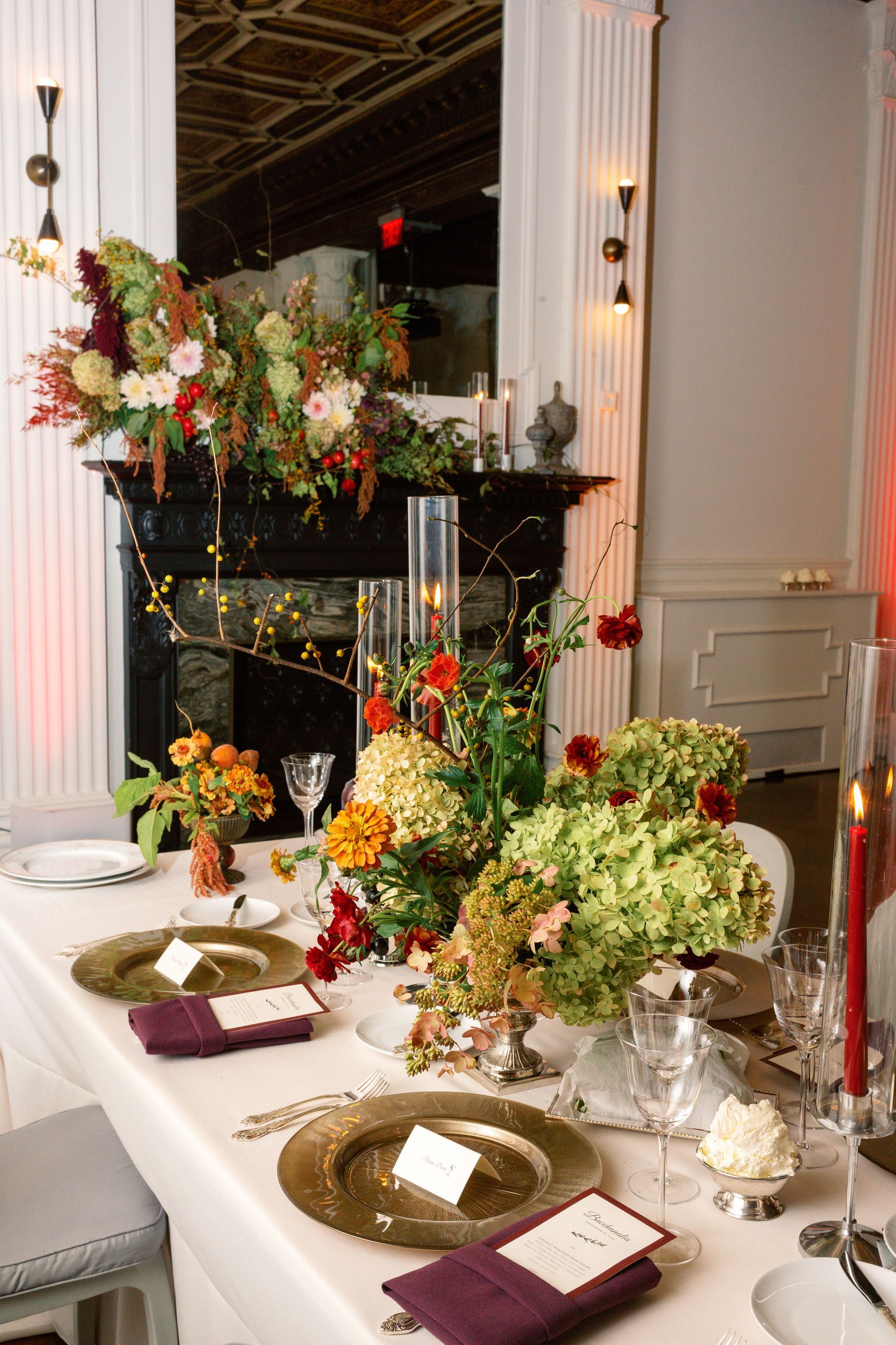 Decorated dining table with floral centerpieces and candles in an elegant room