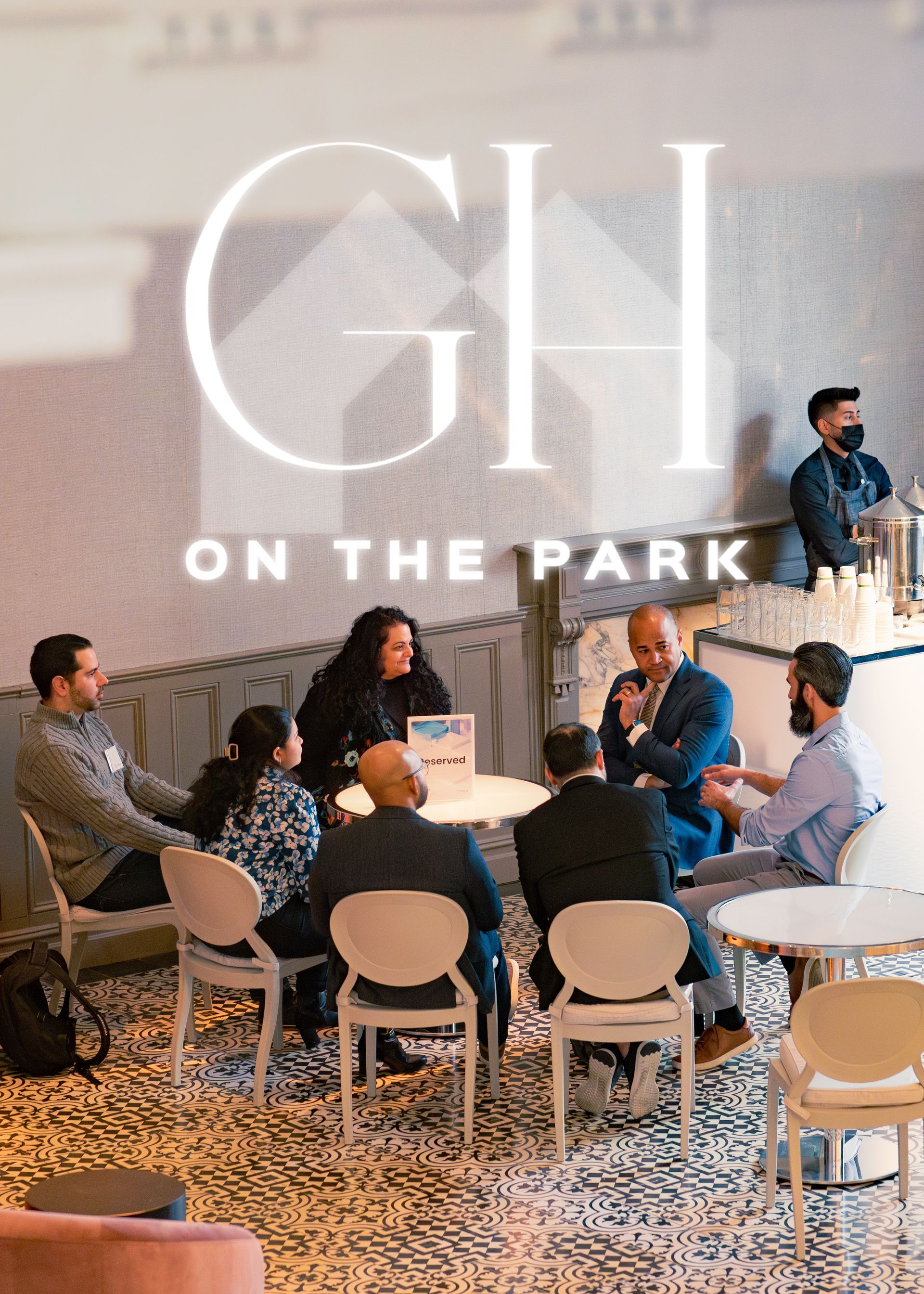 People seated in a modern lounge at GH On the Park during a networking event