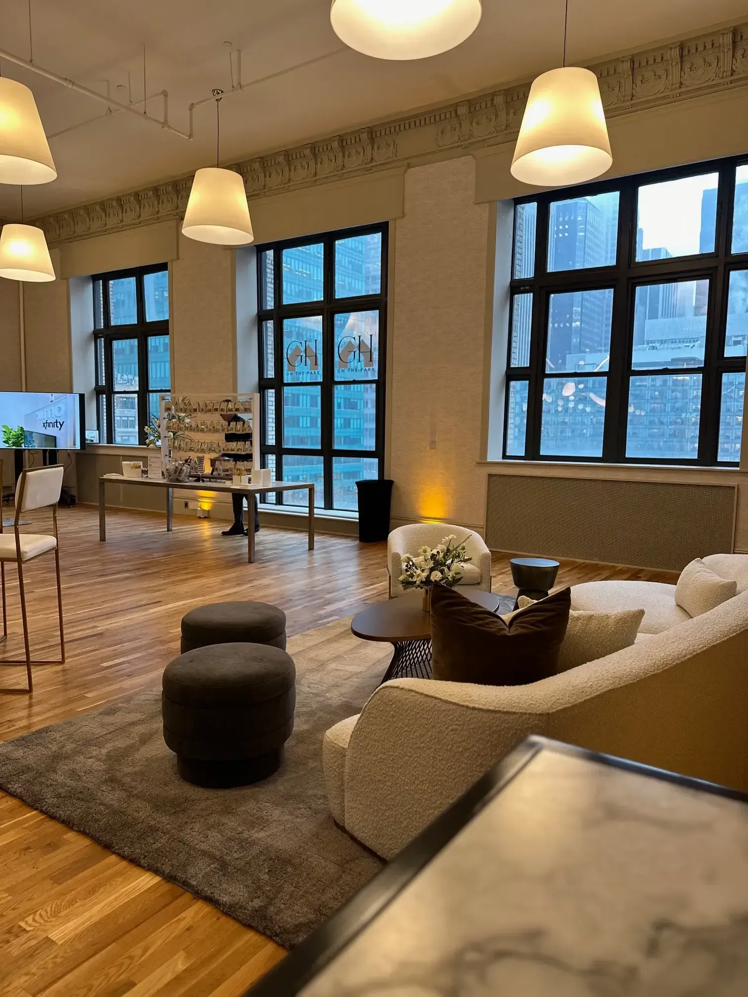 Spacious room with large windows, modern furniture, and cityscape view.