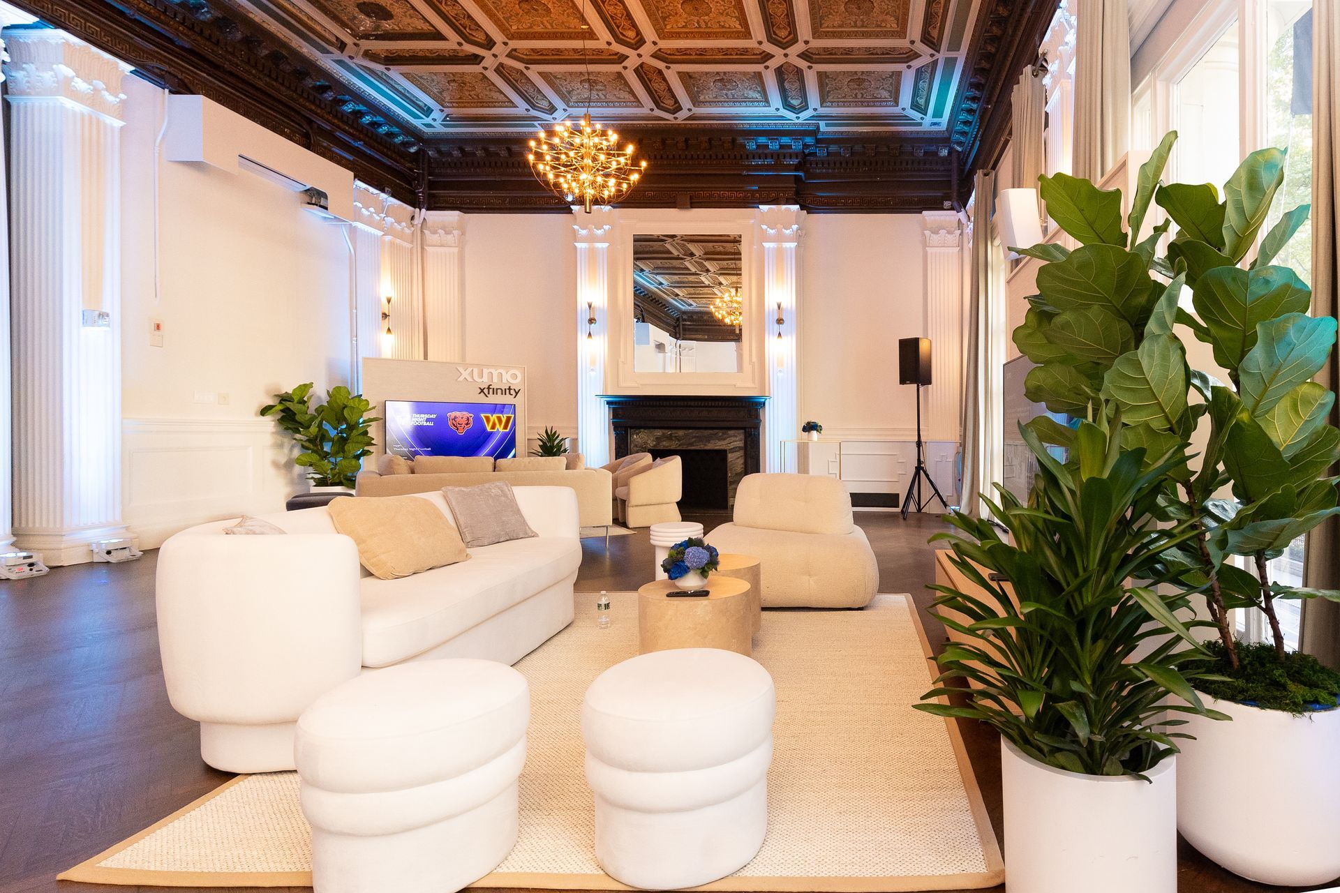a living room with a couch , chair , fireplace and television .