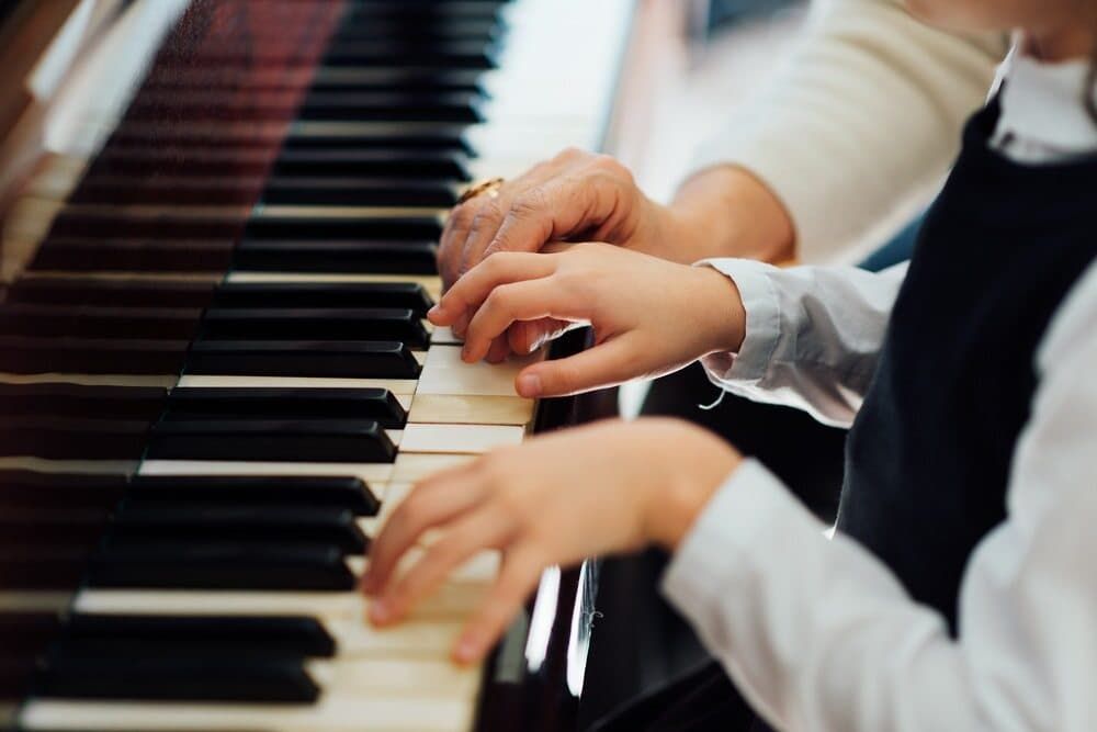 A Woman Is Teaching a Child how To Play the Piano — Tony Prince Piano Tuning In Port Macquarie, NSW