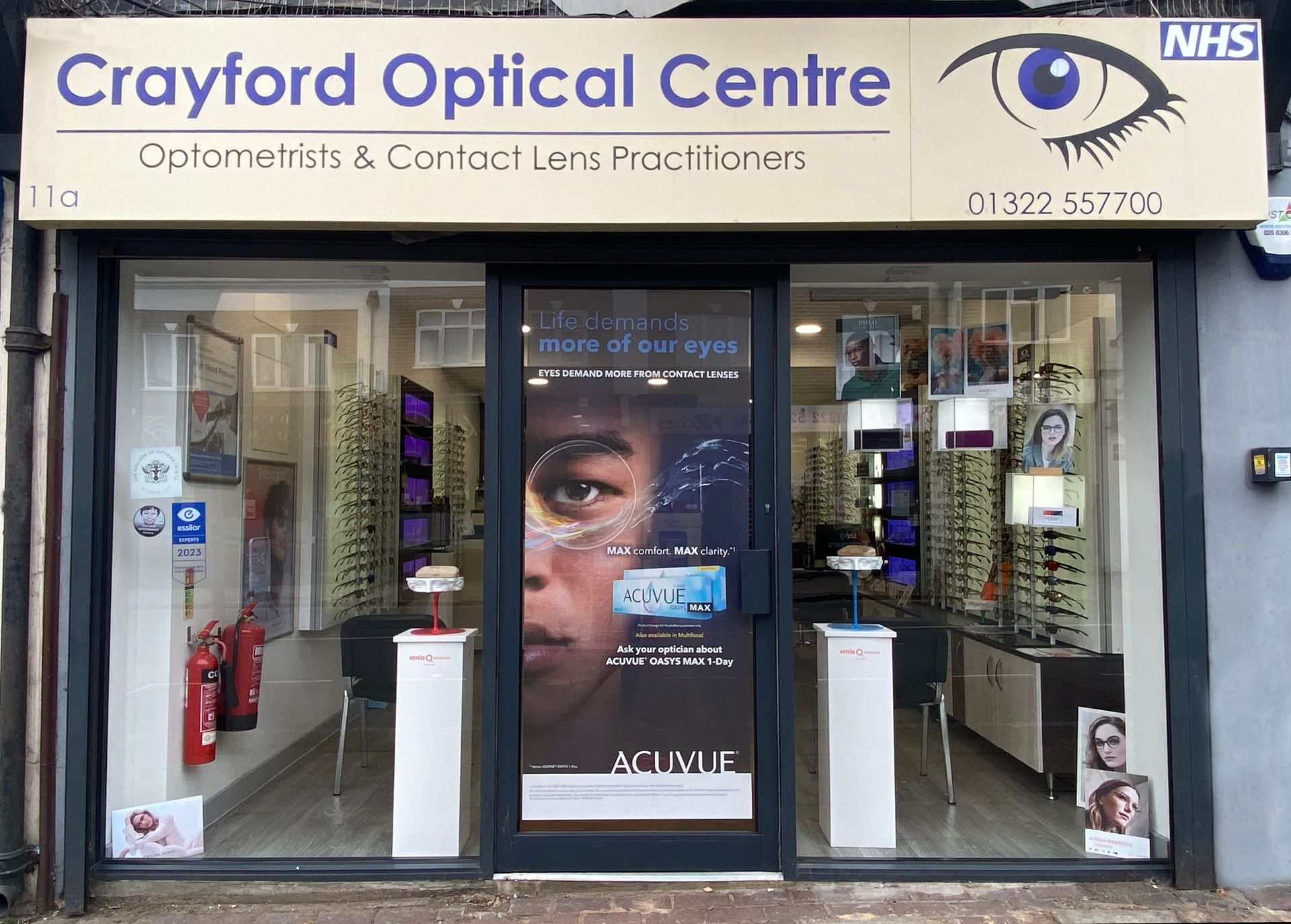 Crayford Optical Centre storefront with eyeglasses display, door ad, and NHS logo.