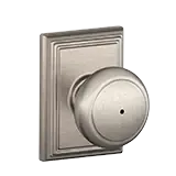 Silver door knob on a rectangular brushed metal backplate