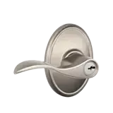 Brushed nickel lever door handle on a round rosette, isolated on white