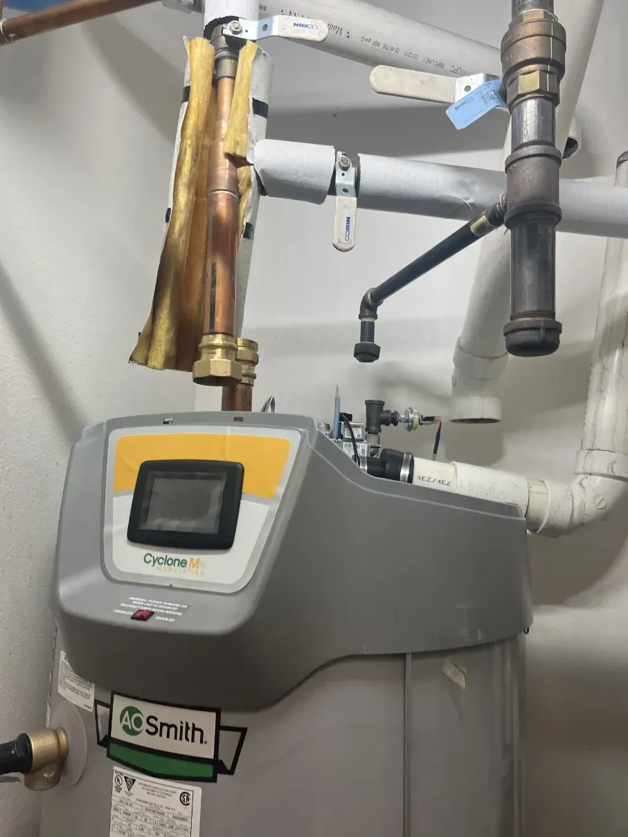 Industrial water heater with pipes and gauges in a utility room
