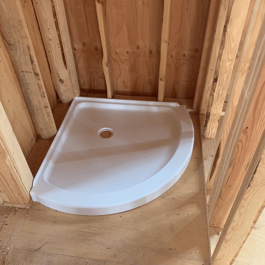 A bathroom featuring a visible pipe and a water heater mounted on the wall.