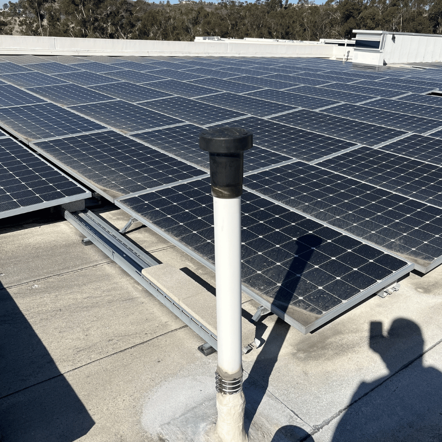Solar panel installed on a roof, casting a shadow on the surface below.