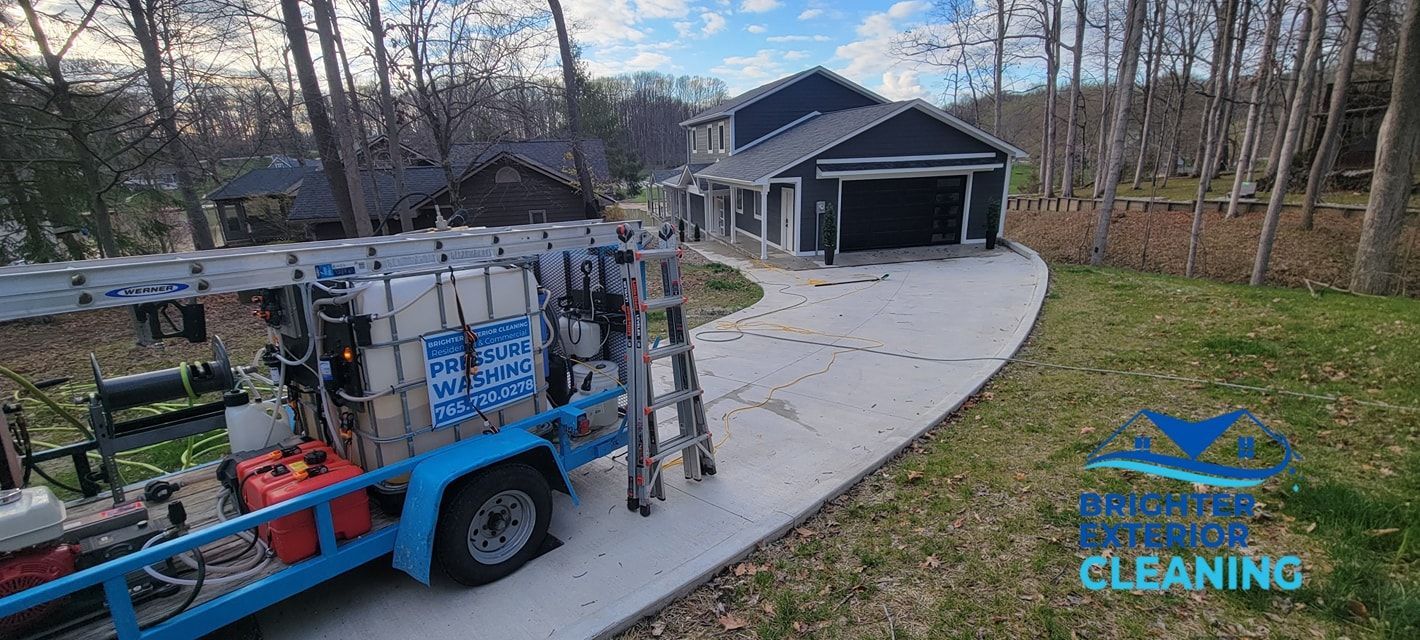A blue truck is parked in front of a house.