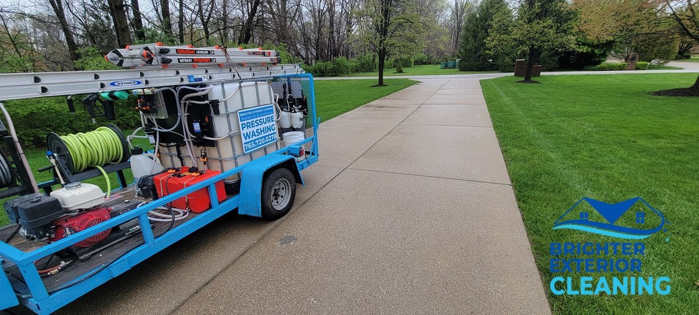 A blue cleaning truck is parked on the side of a road.
