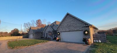 A large brick house with a garage and a driveway.