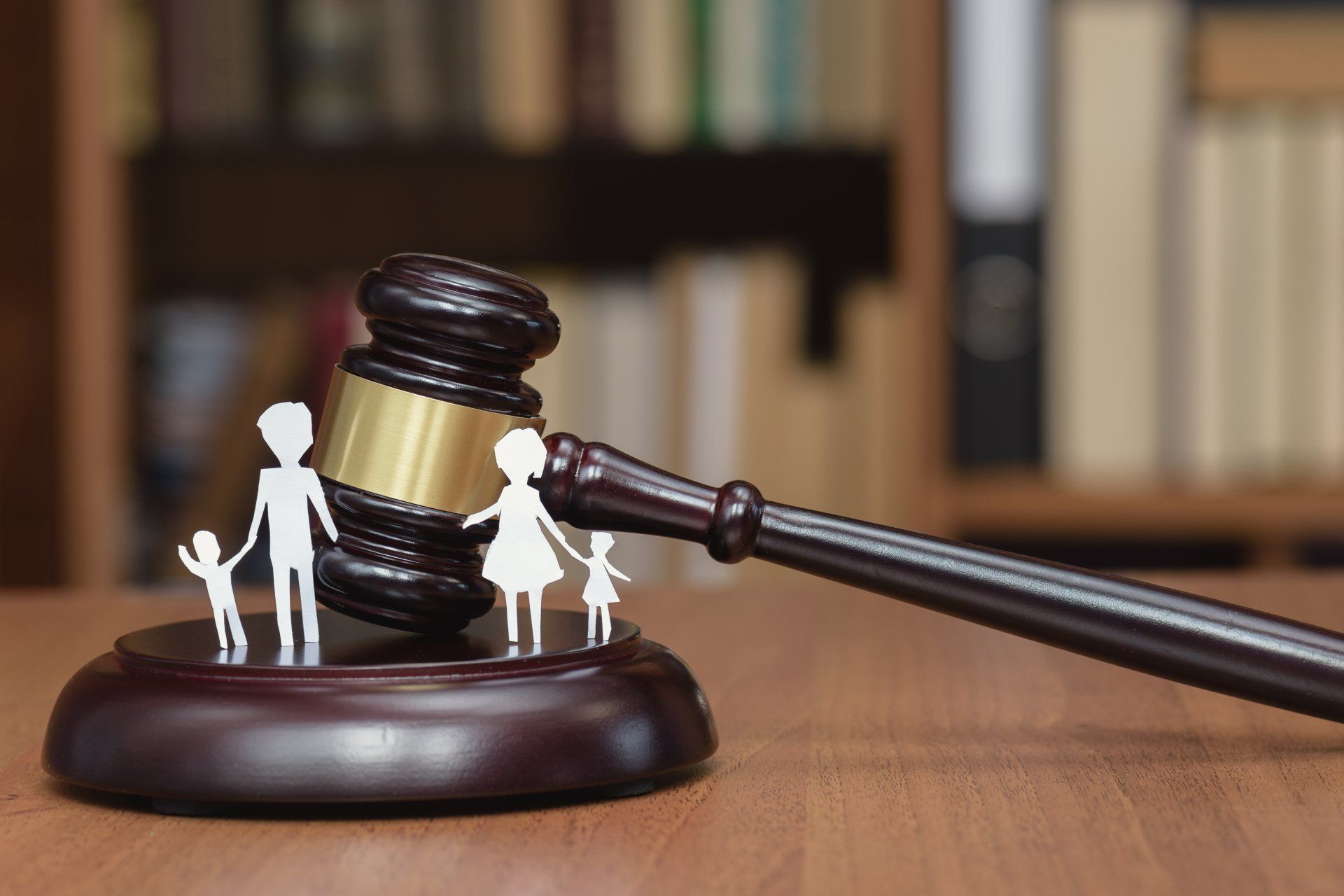 A wooden judge 's gavel with a family cut out of it.