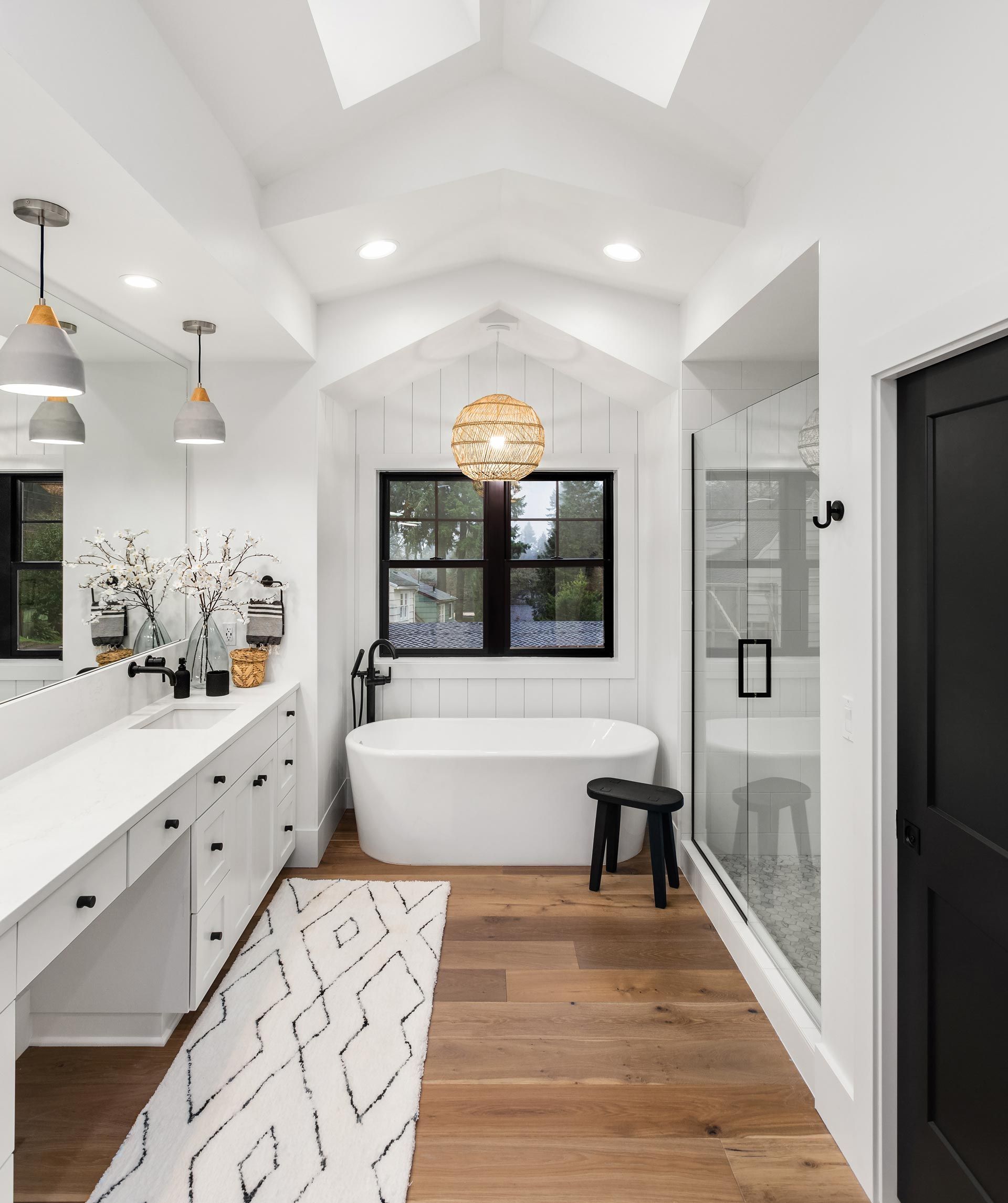 A bathroom with a bathtub , sink , and shower.