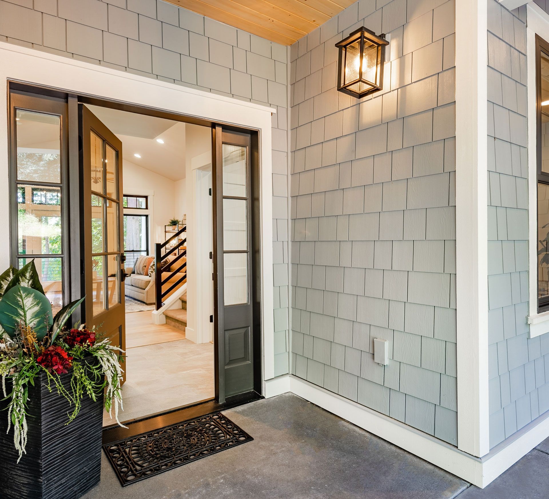 The front door of a house is open to a living room