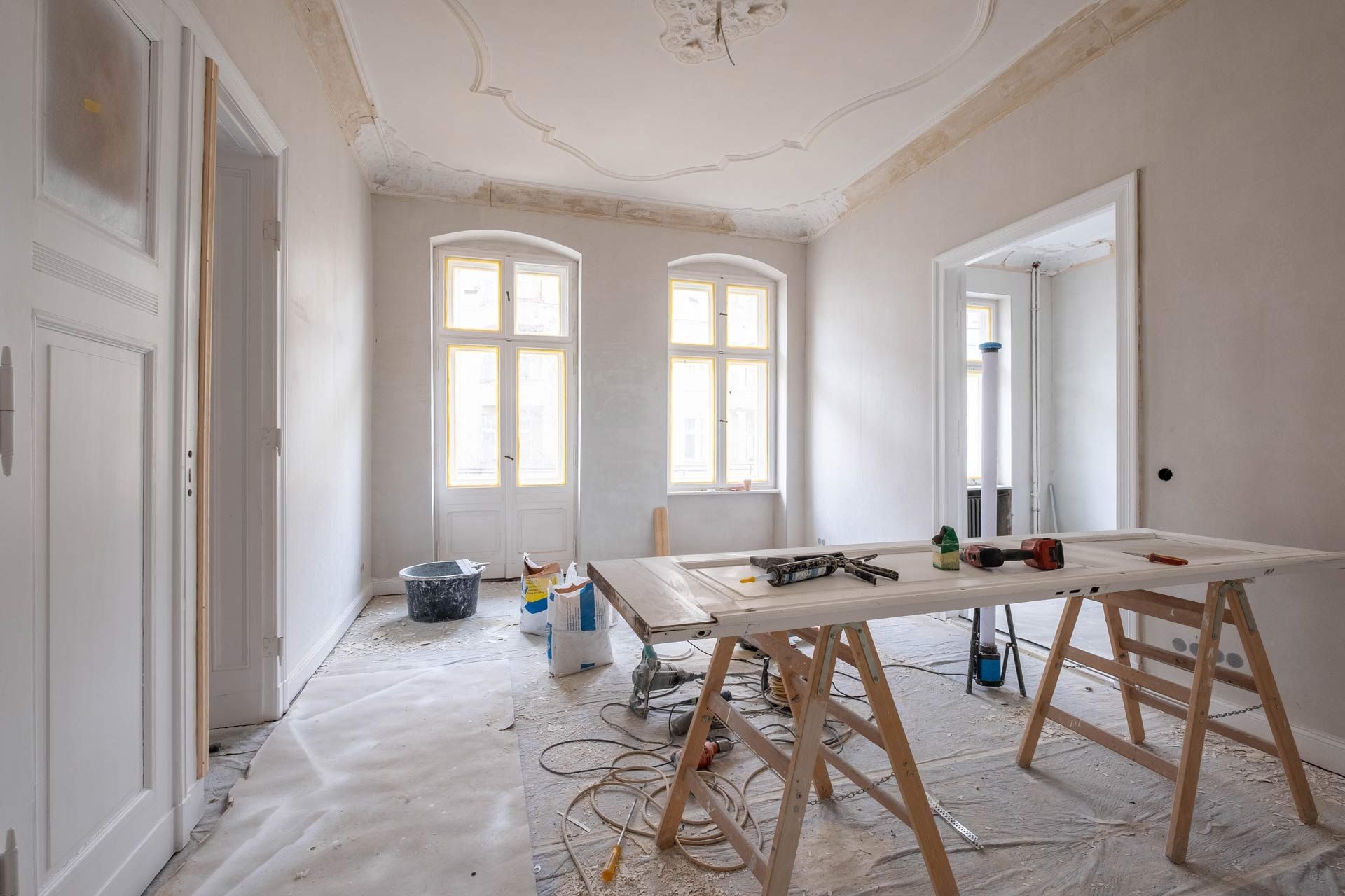 A room under construction with a table and tools on it.